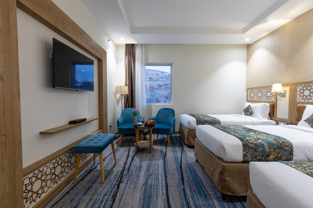 麦加TIME Ruba Hotel & Suites的一间酒店客房,设有两张床和电视