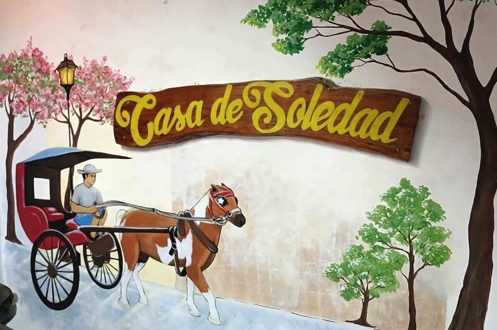 美岸Casa De Soledad Vigan City的画马车里的人的画