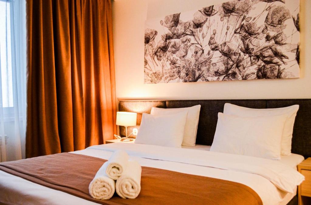 阿斯塔纳Yes Апарт-отель的一间卧室配有带毛巾的床