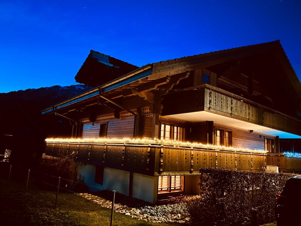 伊瑟尔特瓦尔德Chalet Swiss Alpine Haven的一座晚上有灯的建筑