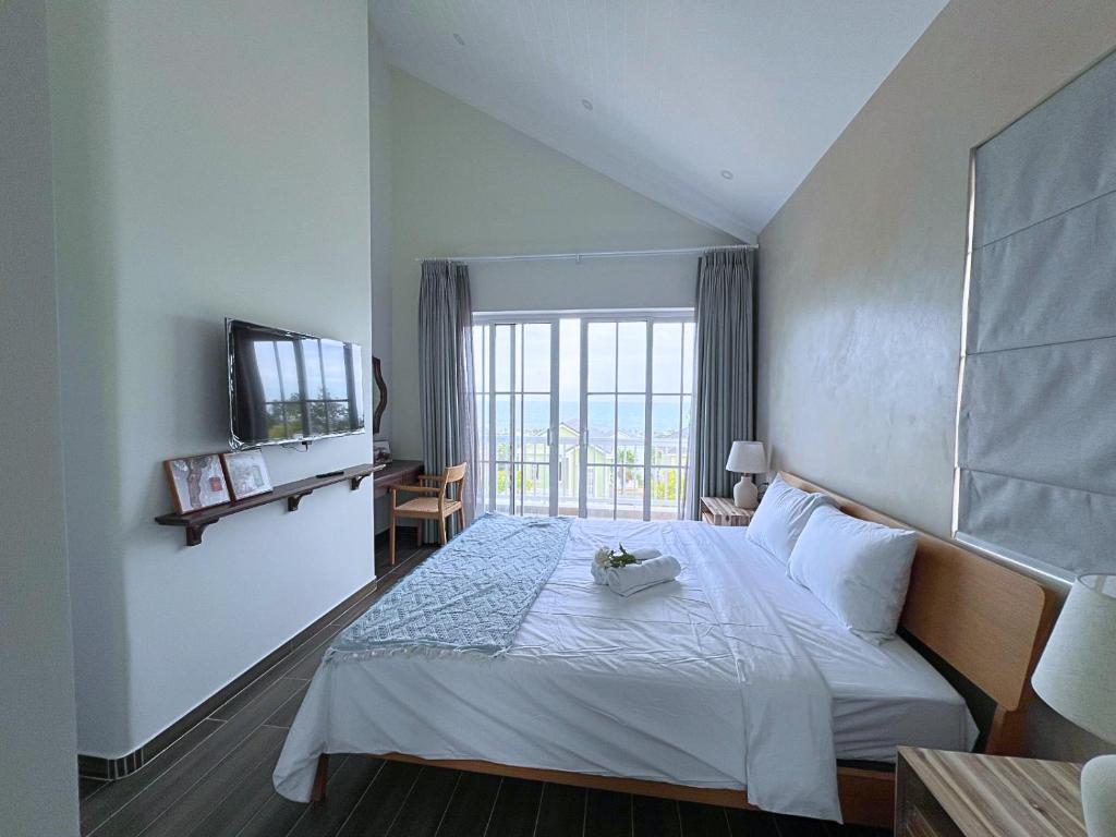 潘切Seamoni Seaview Villa 02 - Novaworld Phan Thiết的酒店客房,配有床和电视