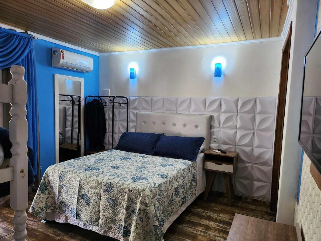 佩尼亚Beto Pousada的卧室配有一张带蓝色灯光的墙壁床。