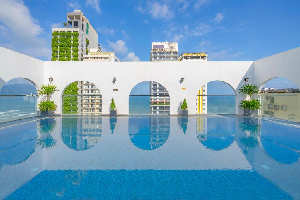 岘港Golden Lotus Hotel Da Nang的一座拥有建筑背景的游泳池