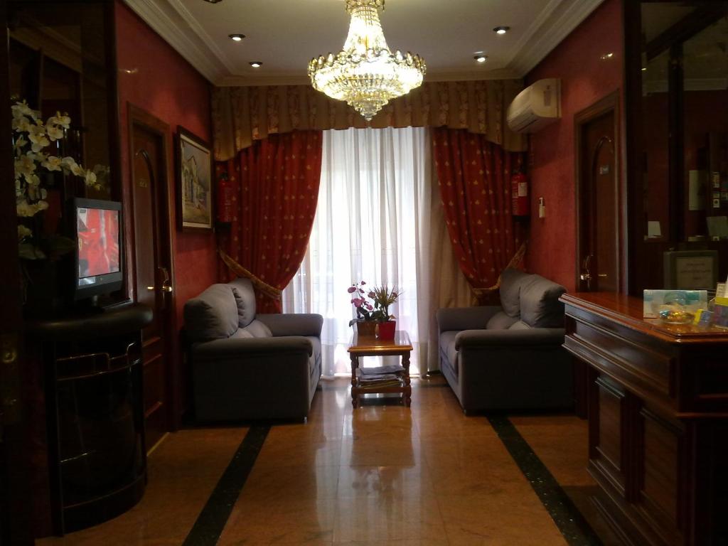 马德里Hostal Centro Sol Madrid的客厅配有两张沙发和一个吊灯。