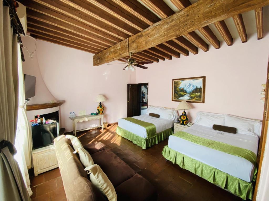 库埃纳瓦卡乐斯特拉瑟斯博尼塔别墅酒店的一间卧室配有两张床和一台平面电视
