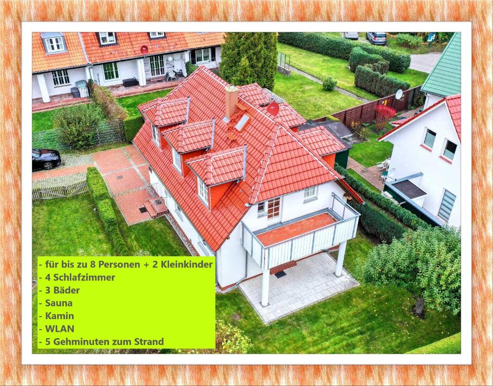 青斯特Haus Admiral mit Garten, 5 Gehminuten zum Strand, inklusive WLAN, Sauna, Kamin, Bollerwagen für den Strand的享有红色屋顶房屋的空中景致