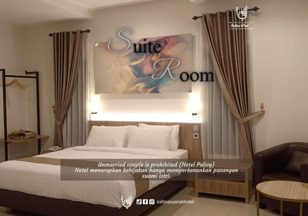 TjileungsirThe Safiina Point Syariah Hotel的酒店客房,配有床和沙发