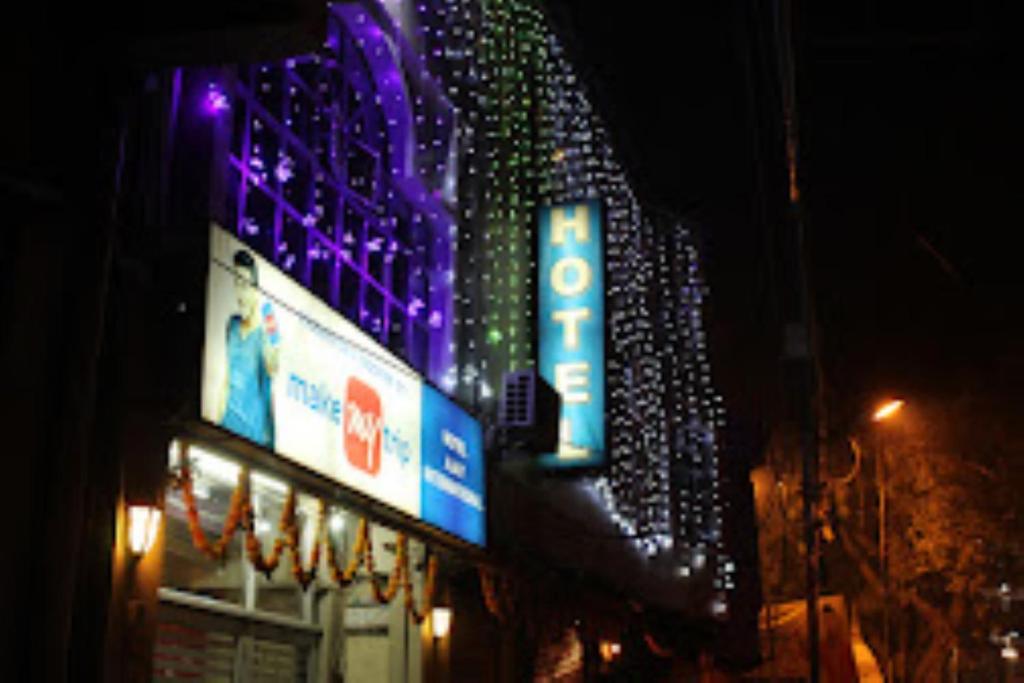 阿格拉Hotel Ajay International Agra的一座晚上有紫色灯光的建筑