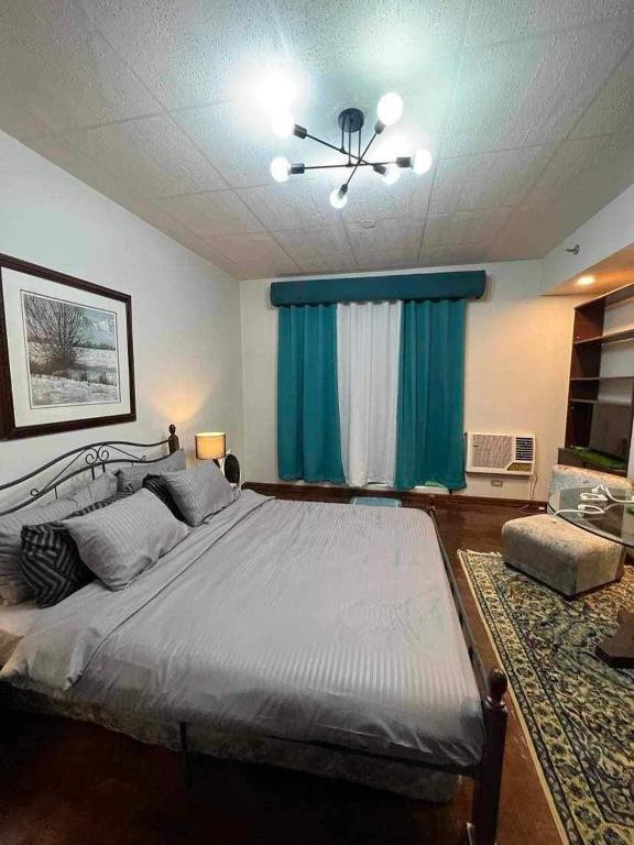 马尼拉Millennium Plaza Hotel的一间卧室配有一张大床和吊扇