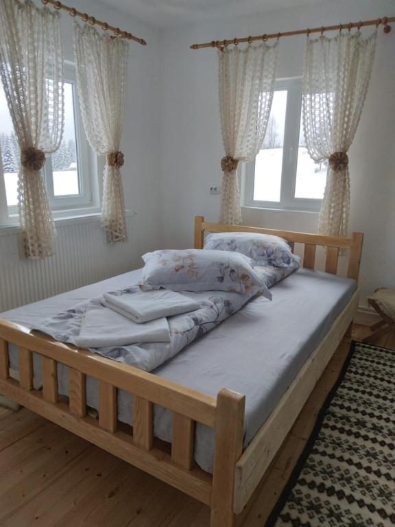 OcoaleCasa din Deal-Apuseni的一间卧室配有一张带枕头的木床