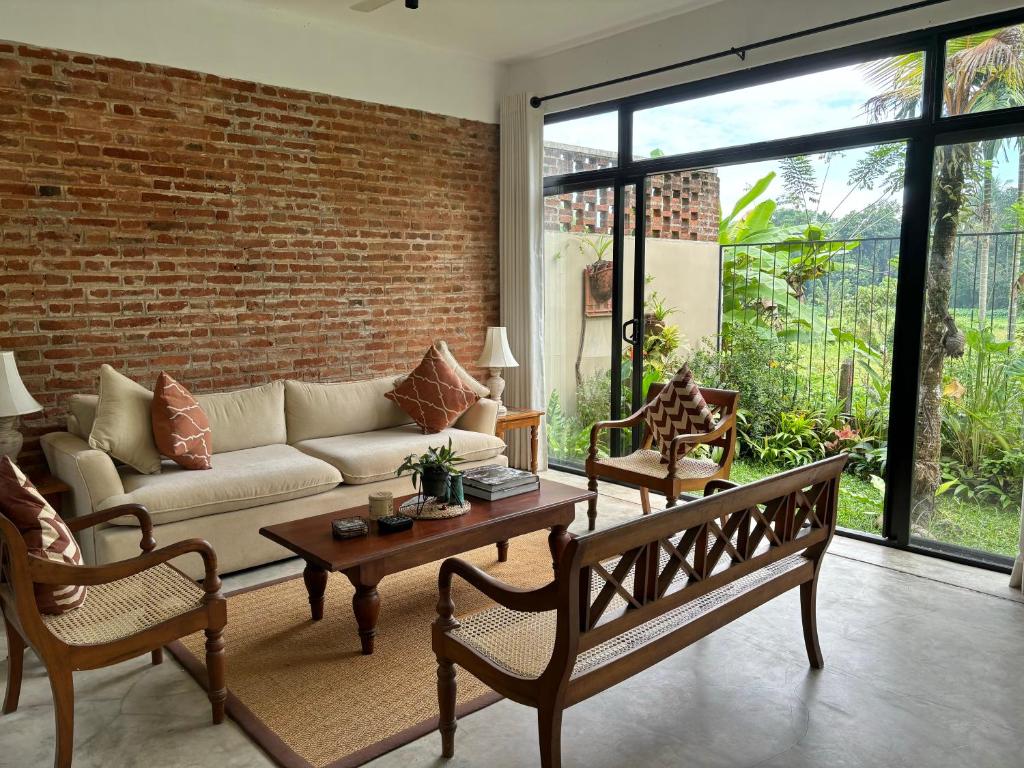 科伦坡Rai Villa Colombo的带沙发和砖墙的客厅