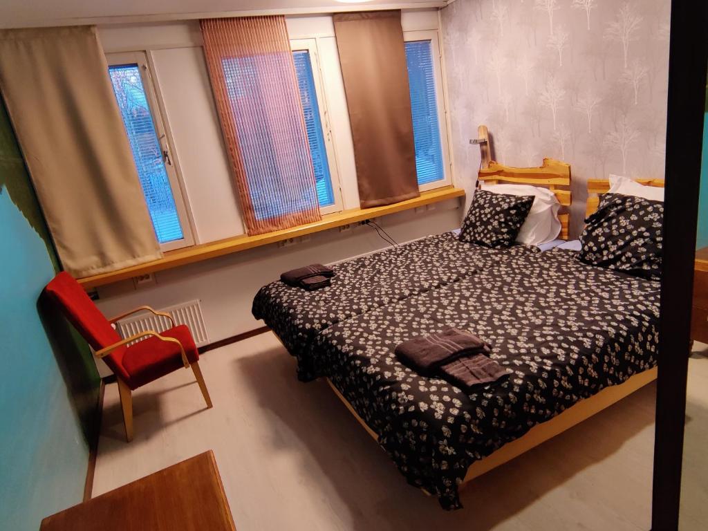 科沃拉Jaala Hotel的一间卧室配有一张床、一把椅子和窗户。