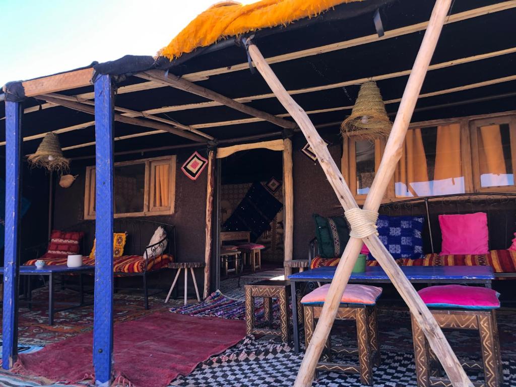 梅尔祖卡Bivouac Le Petit Prince Merzouga的配有带桌椅的帐篷的客房
