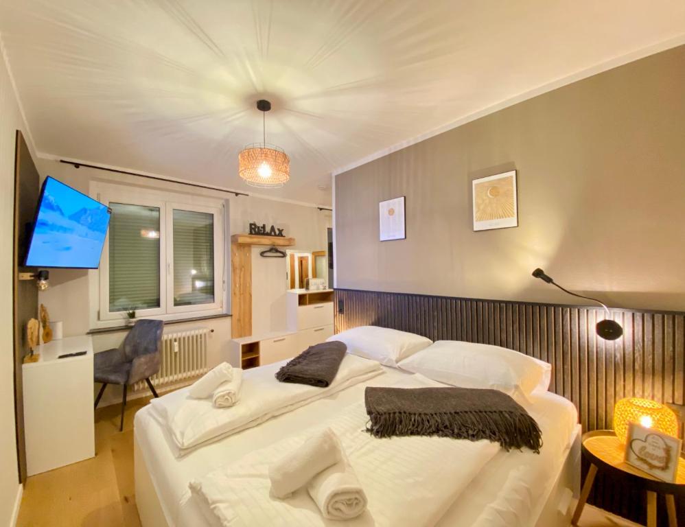 克拉根福BaMo Studio - city living arkaden的卧室配有一张白色大床和电视。