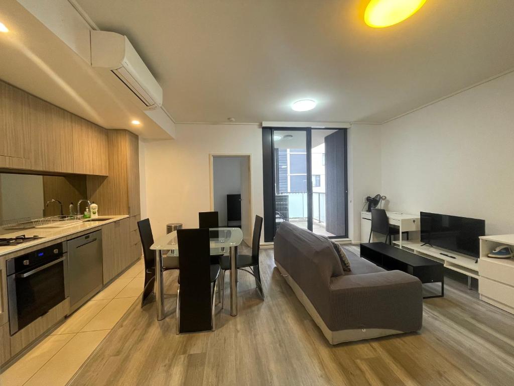 RiverwoodEntire 2 bedrooms Security Apartment的厨房以及带桌椅的起居室。