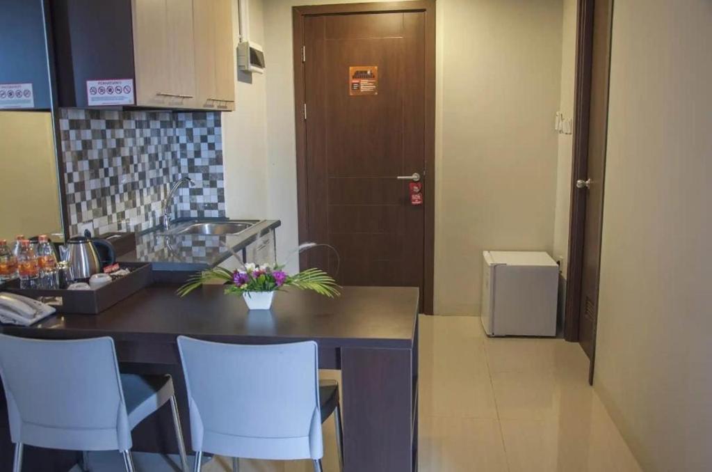 BatulicinMugiwara Hotel&Apartment的厨房配有桌椅和门