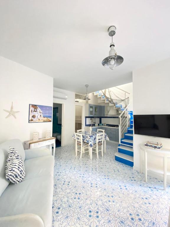 伊斯基亚Arime Apartment的客厅设有白色沙发和楼梯。