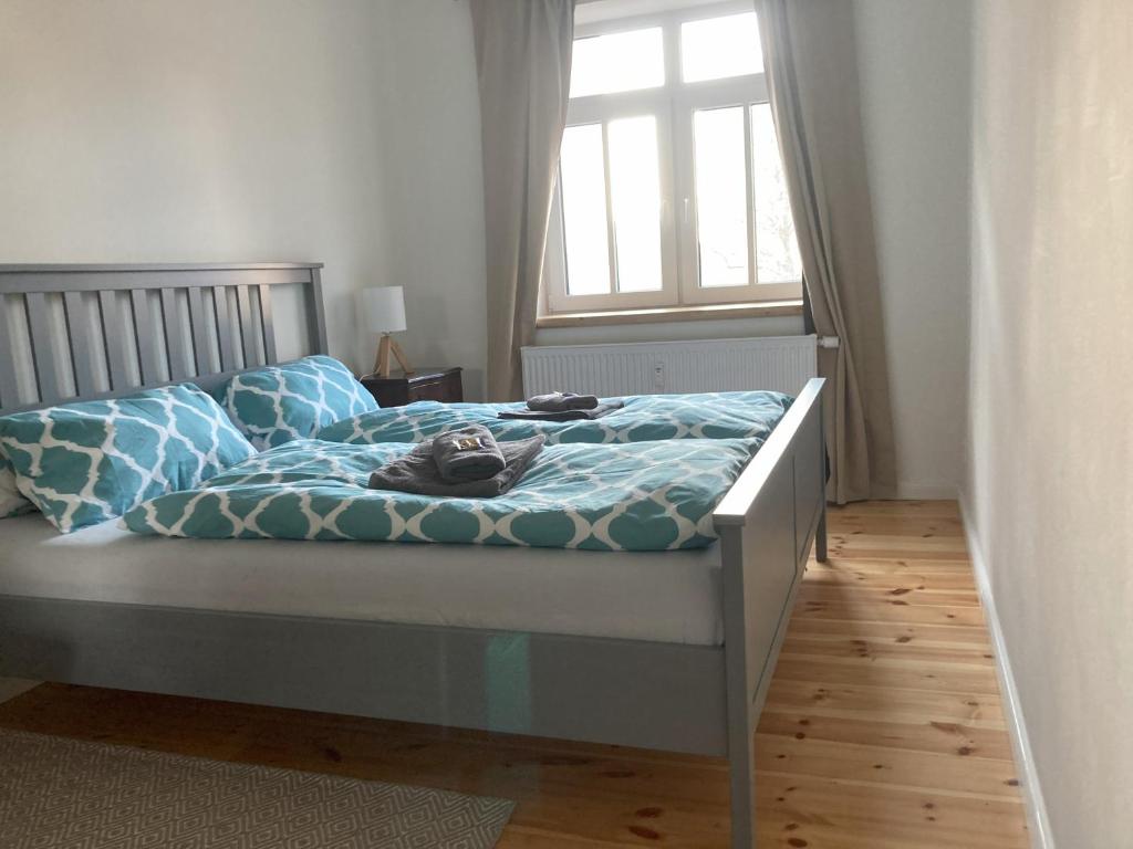 汉诺威SUITE-DREAMS APARTMENT - Innenstadt的一间卧室配有一张带蓝色床单的床和一扇窗户。