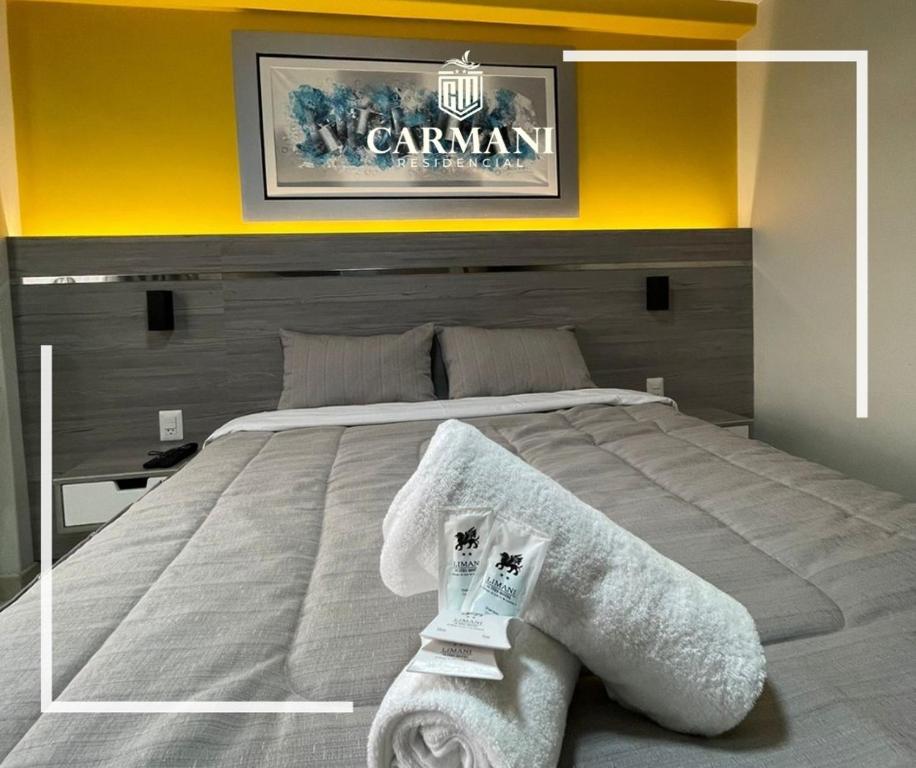 塔克纳RESIDENCIAL CARMANI的一间卧室配有一张大床和毛巾