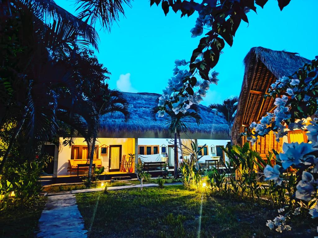 龙目岛库塔Mengalung Bungalow的享有棕榈树庭院景致的度假酒店