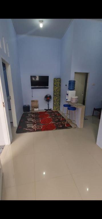 HalanganHomestay Pandan的一间客厅,配有地毯和墙上的电视