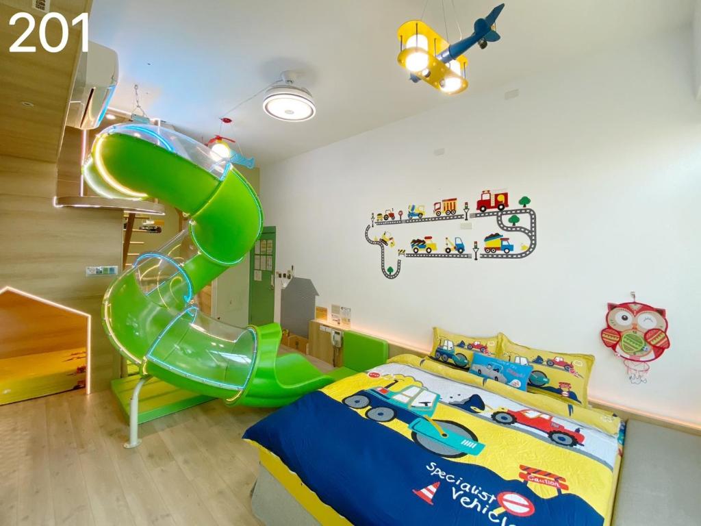 后里风自然亲子时尚旅宿的儿童间 - 带绿色滑梯和床