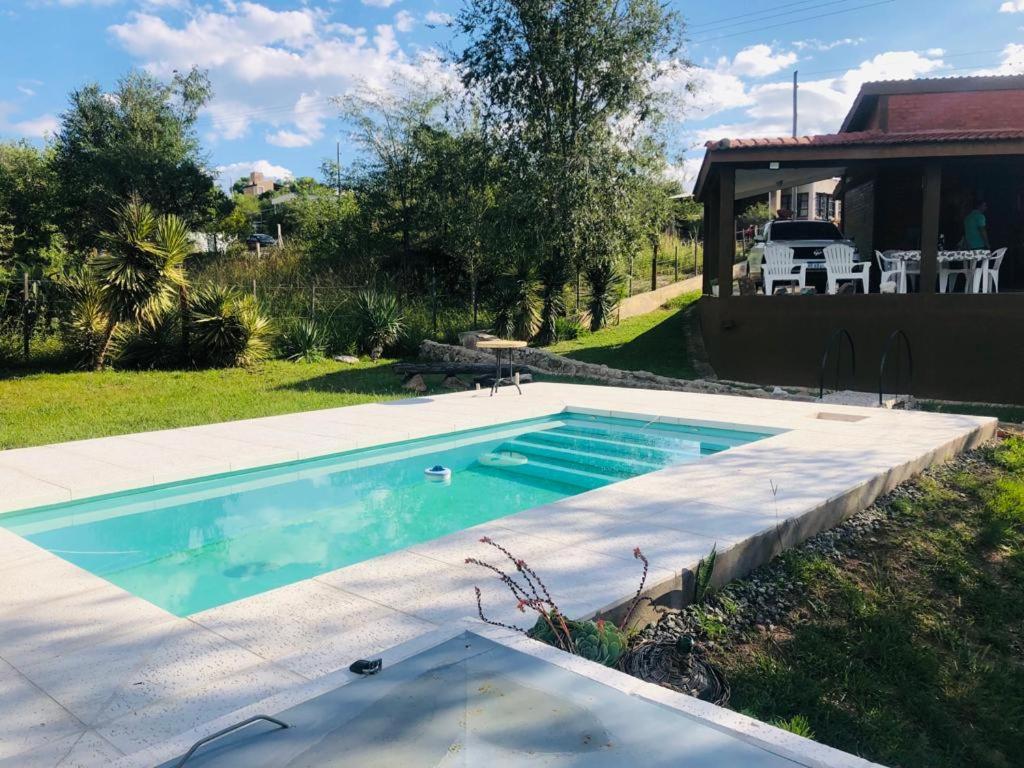 维拉帕尔克西基曼Casa amplia con pileta的一座带房子的庭院内的游泳池