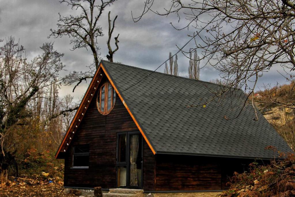KatsʼkhiKatskhi Cottage, Your Cozy Stay的一间黑色屋顶的小房子