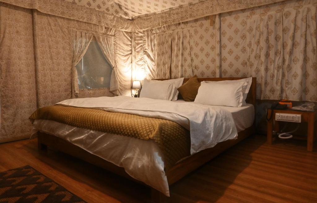 RājgarhBundeli Resorts的一间卧室配有一张带天蓬的大床