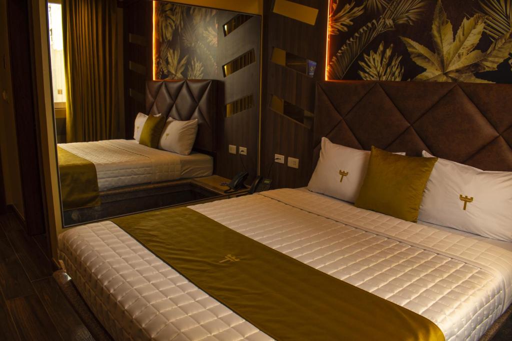瓜亚基尔FORTICH APART HOTEL的一间卧室配有两张床和镜子