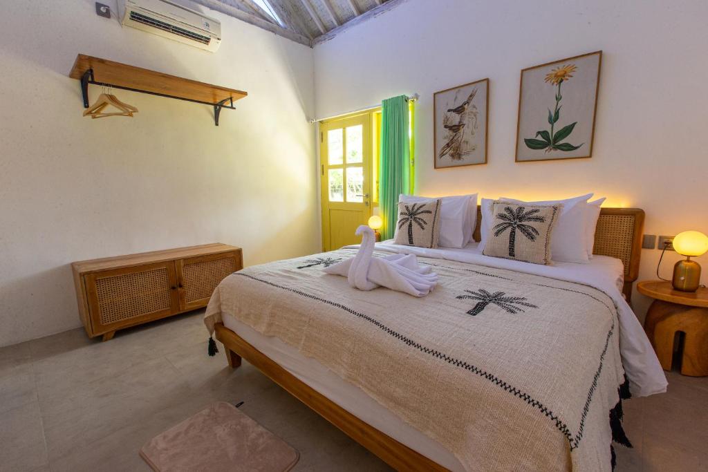 珀尼达岛La Roja Bungalows的一间卧室配有一张床,床上有毛巾