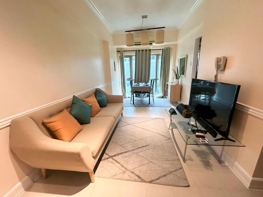 马尼拉Affordable Staycation Airbnb BGC的带沙发和电视的客厅
