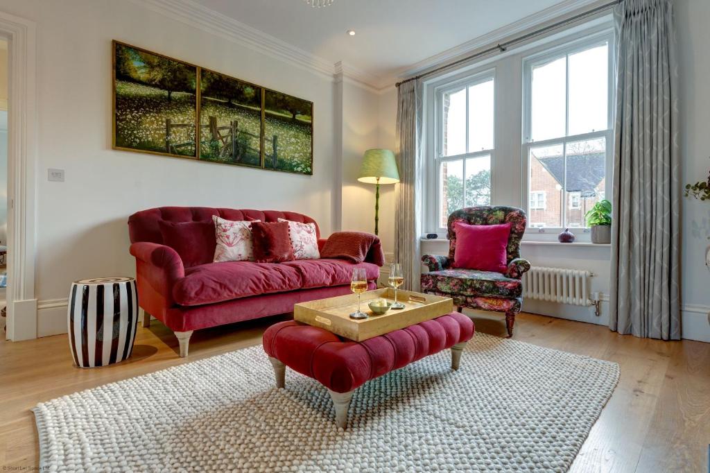 牛津University Parks View的客厅配有红色的沙发和两把椅子
