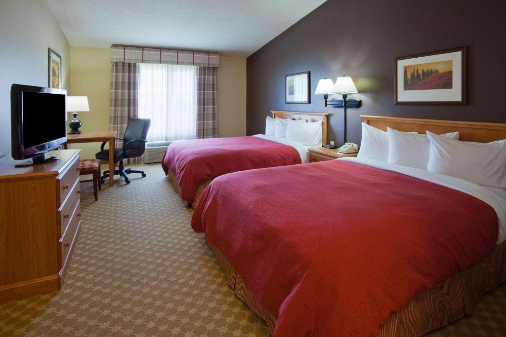 沃特敦水城卡尔森乡村旅馆及套房酒店的酒店客房设有两张床和一台平面电视。