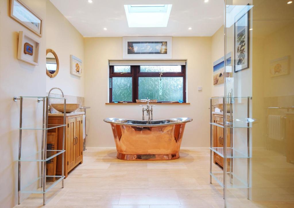 圣艾夫斯High quality detached house with parking St. Ives的一间带铜浴缸和水槽的浴室