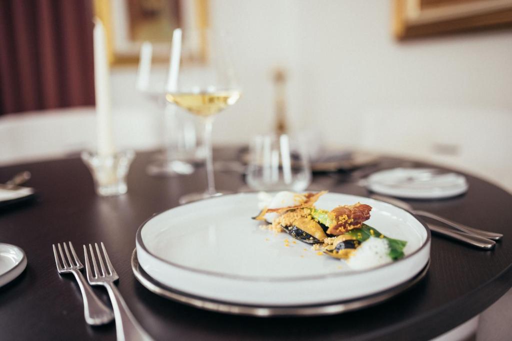 圣格特鲁德瓦尔德阿尔提莫Haus Elisabeth的桌上的一小块食物,加上一杯葡萄酒