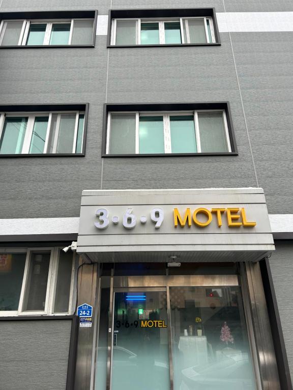 木浦市369 Motel的商店前有酒店标志的建筑物