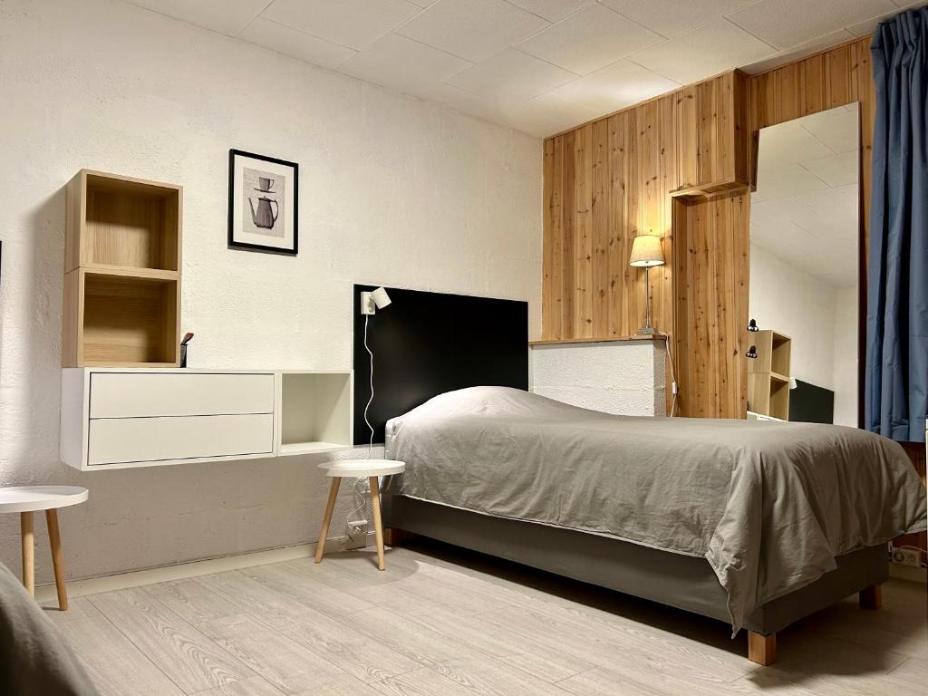 特隆赫姆Simple room的一间卧室配有床、两张桌子和镜子