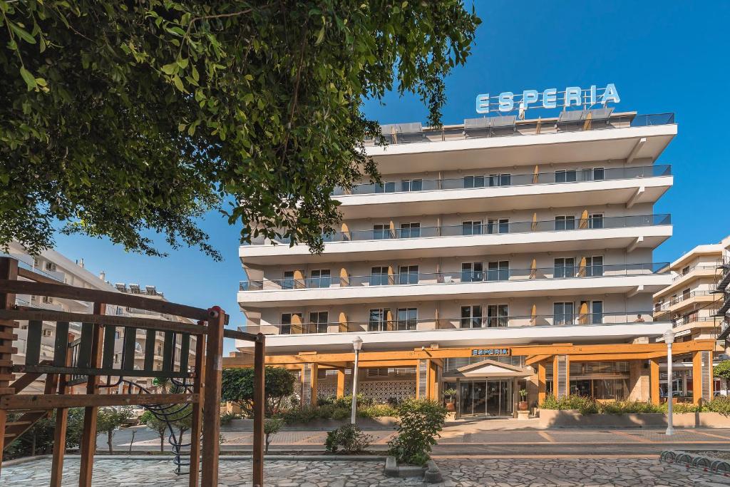 罗德镇Esperia City Hotel的一座白色的大建筑,上面有标志