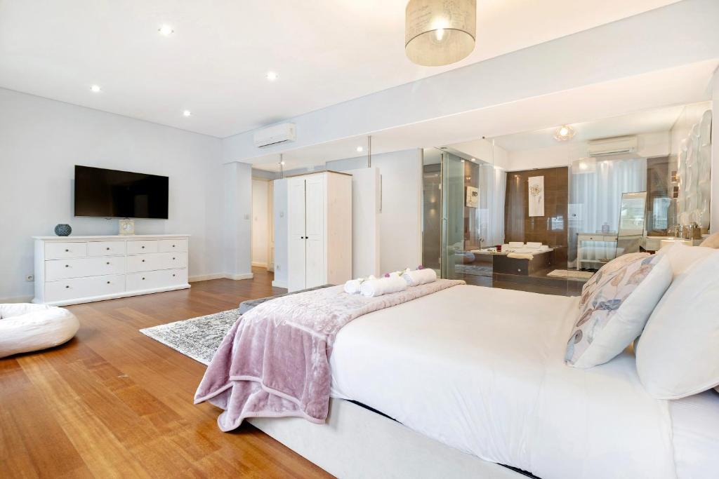波尔图Apartment Boutique Santa Catarina 2的白色的卧室设有一张大床和一间浴室。