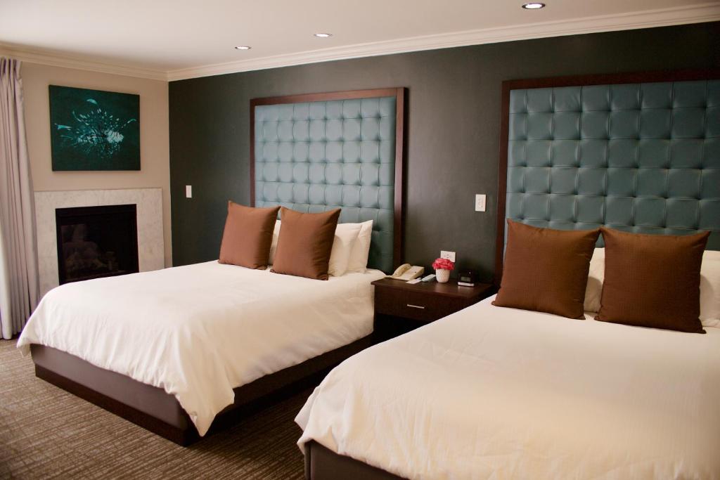 蒙特雷蒙特利浪子旅馆的酒店客房设有两张床和壁炉
