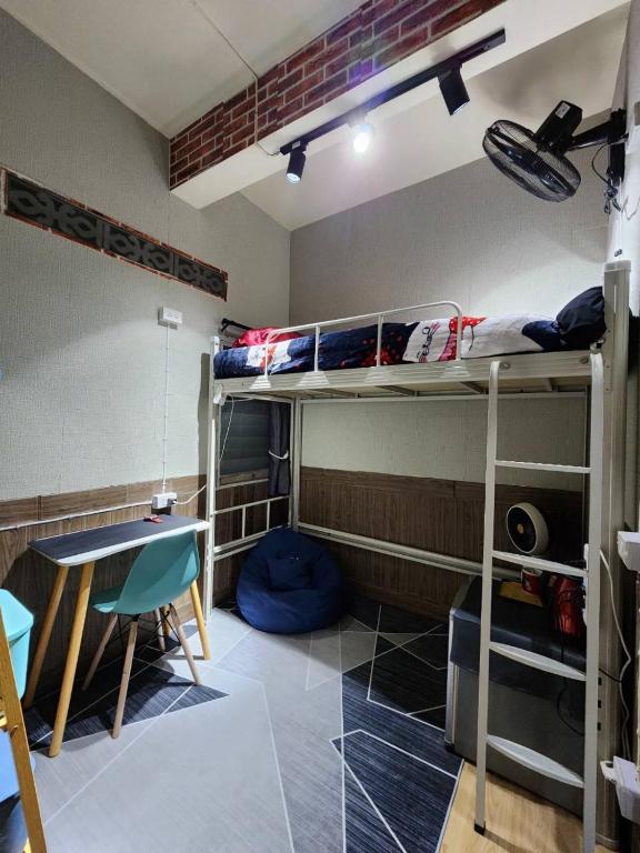 曼谷113 Quiet and Cozy Loft Apartment with free Wi-fi的客房设有两张双层床和一张桌子。