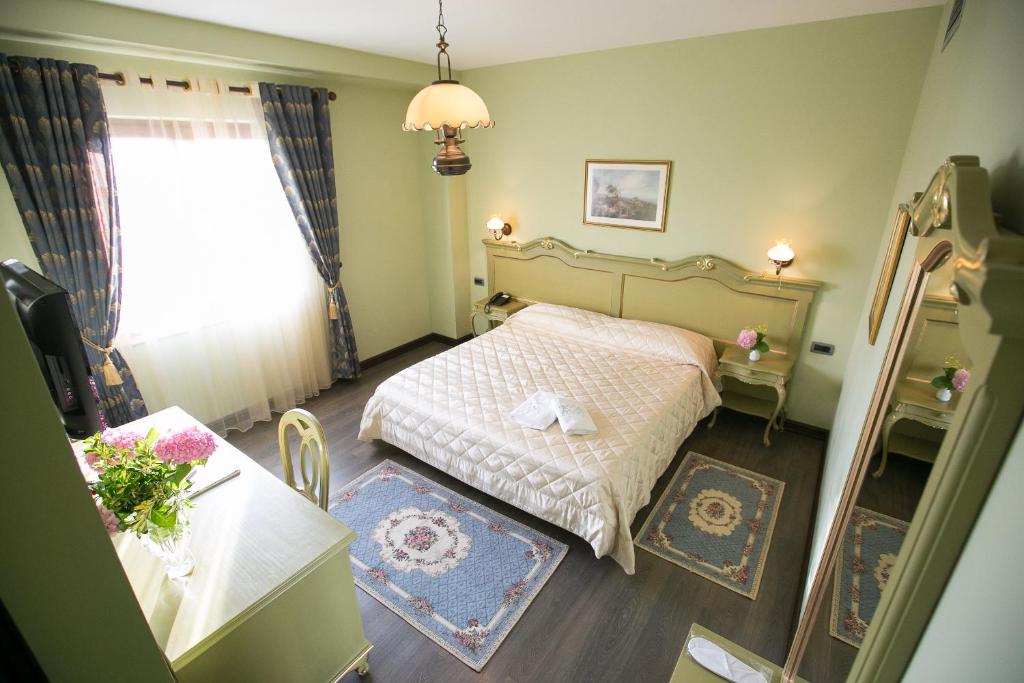 地拉那地拉那维多利亚酒店的一间小卧室,配有床和窗户