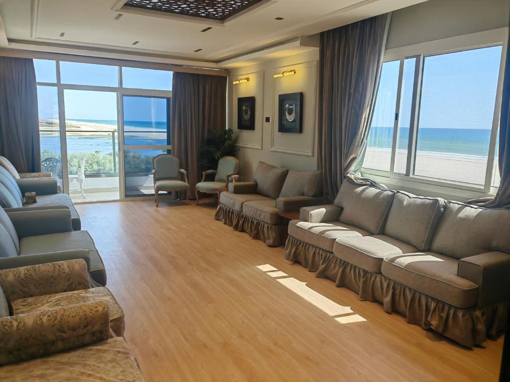 塞拉莱الشقة البحرية الدهاريز的带沙发和椅子的客厅以及海洋