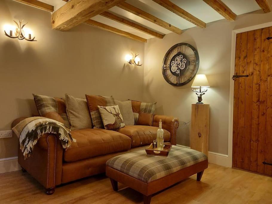 贝尔珀Woodys Retreat Cosy One Bed Cottage的客厅配有棕色沙发和桌子