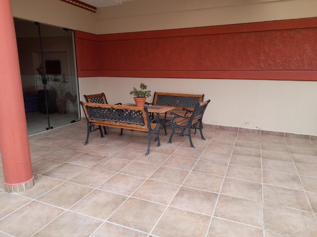 塔里哈Cómo en hogar的一间铺有瓷砖地板并配有桌椅的用餐室