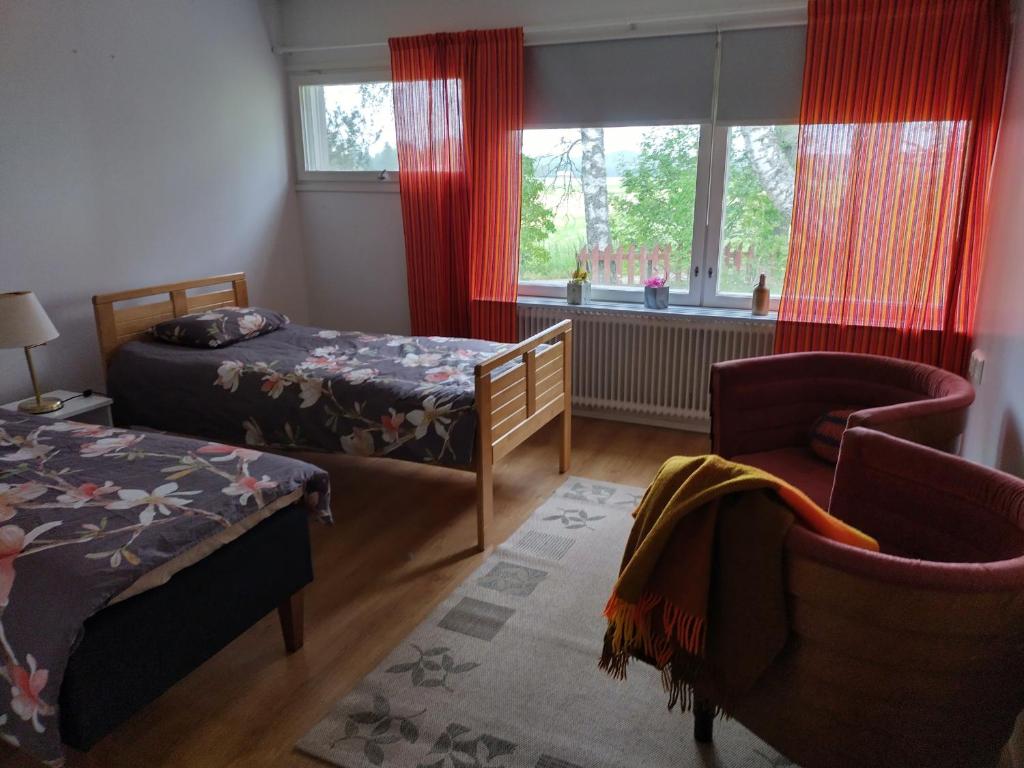 海门林纳Saarnimaja的一间卧室设有两张床、一把椅子和一个窗户。