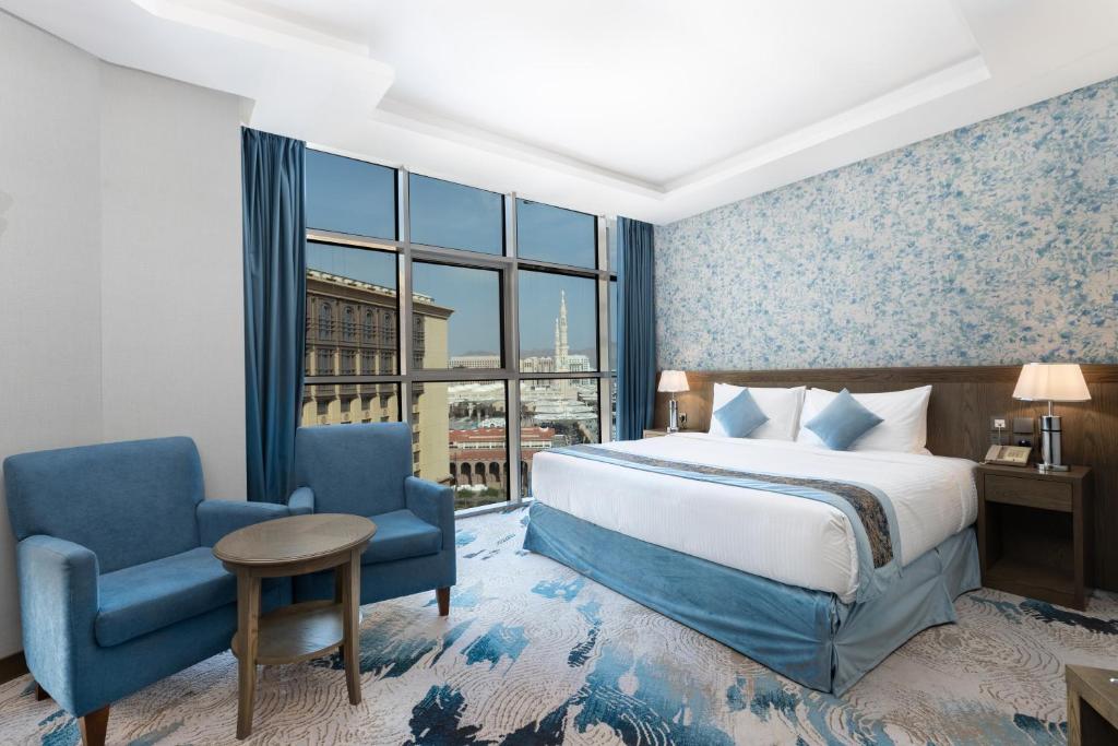 麦地那View Al Madinah Hotel的酒店的客房 - 带一张床、椅子和窗户