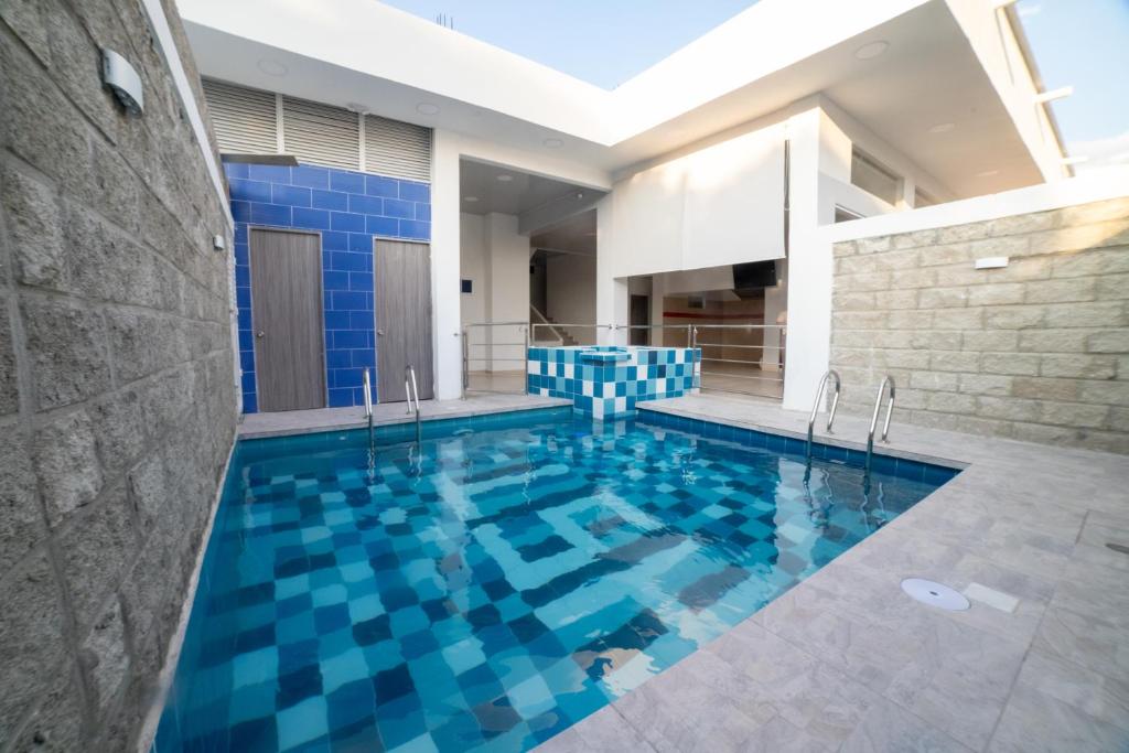圣玛尔塔Hotel Santa Marta Tropical的一座蓝色瓷砖的游泳池