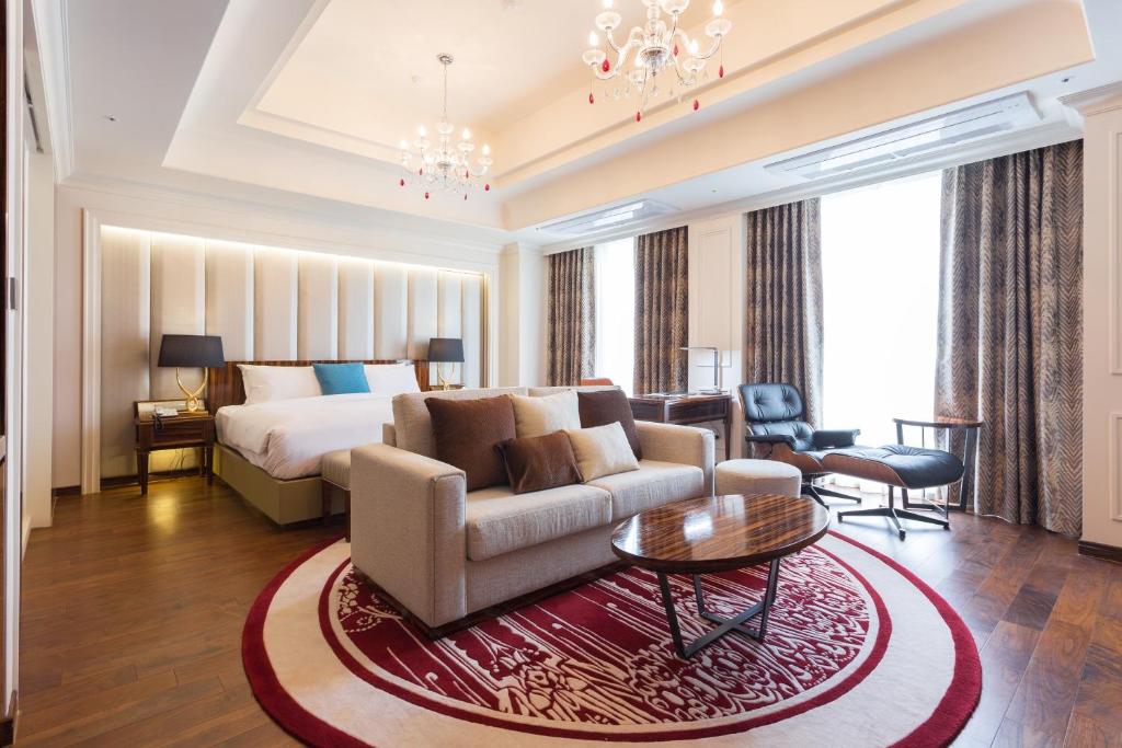 仁川市查理斯酒店的酒店客房配有床、沙发和桌子。